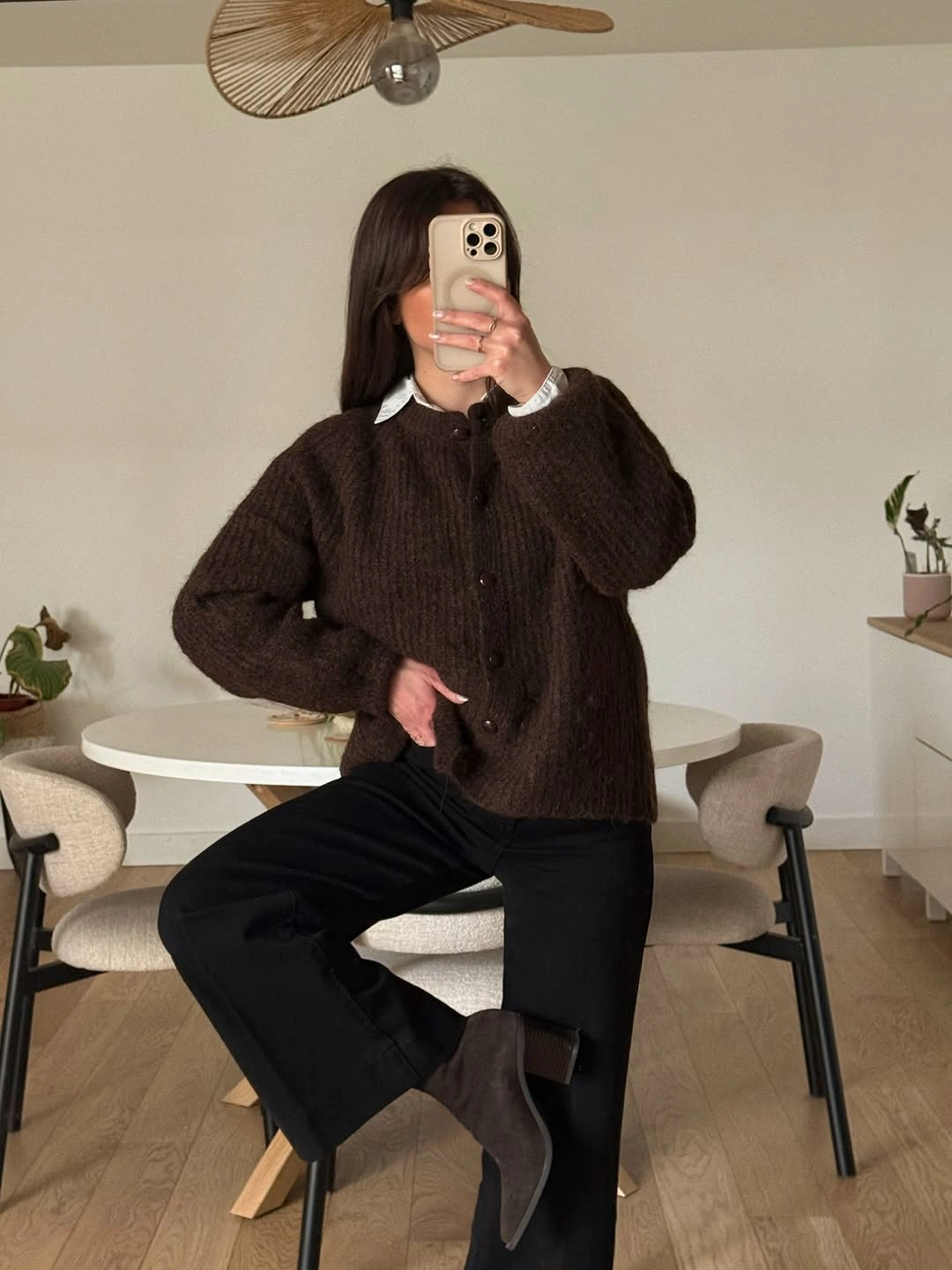 Brown buttoned cardigan with white collar black trousers and ankle boots