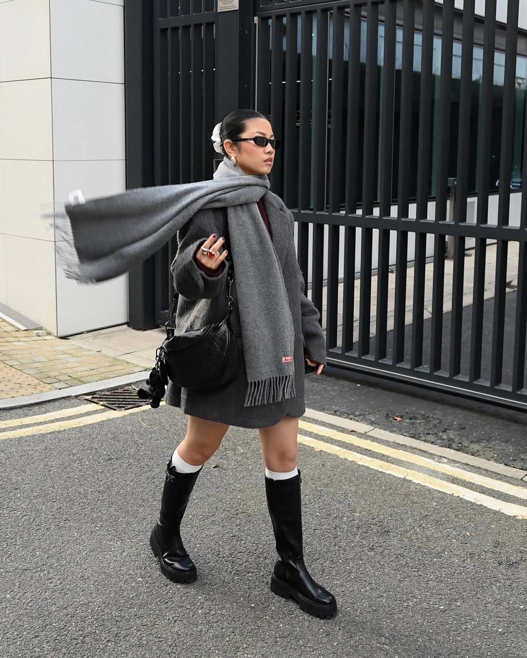 Charcoal oversized knit with long gray scarf and black boots