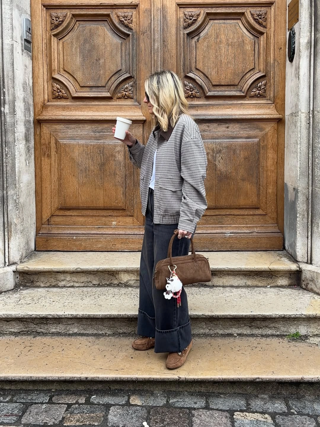 Gray checked blazer with dark wide trousers and brown handbag