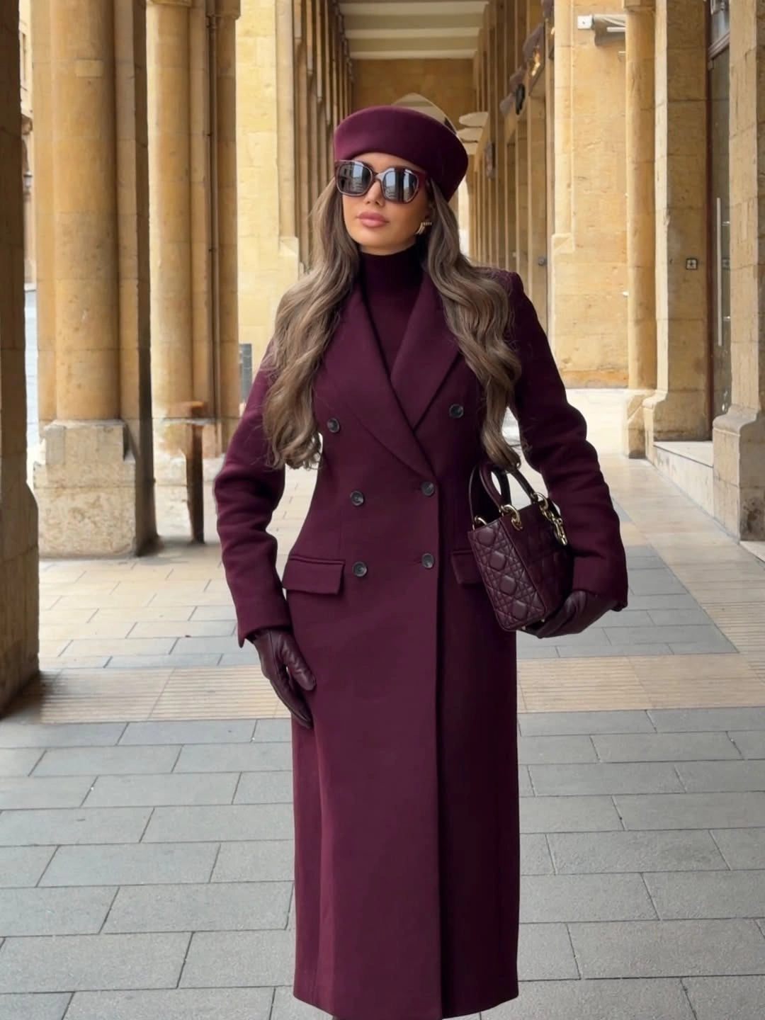 Long burgundy coat with matching beret gloves and handbag