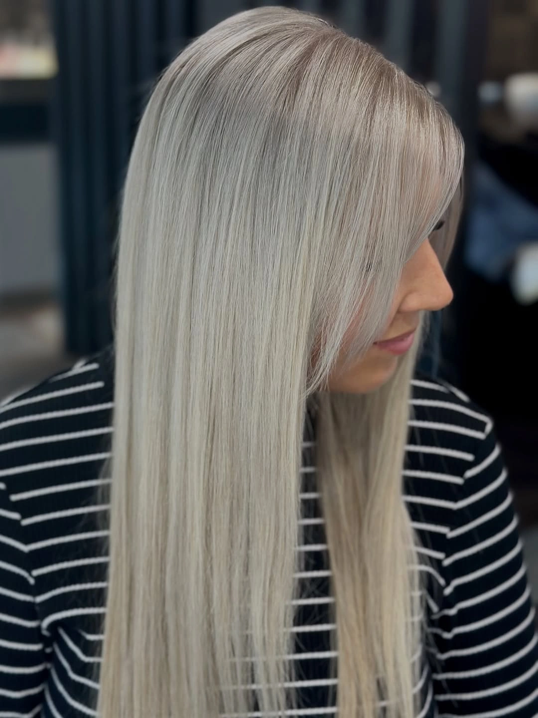 Very long pale blonde hair with beige gray curtain bangs
