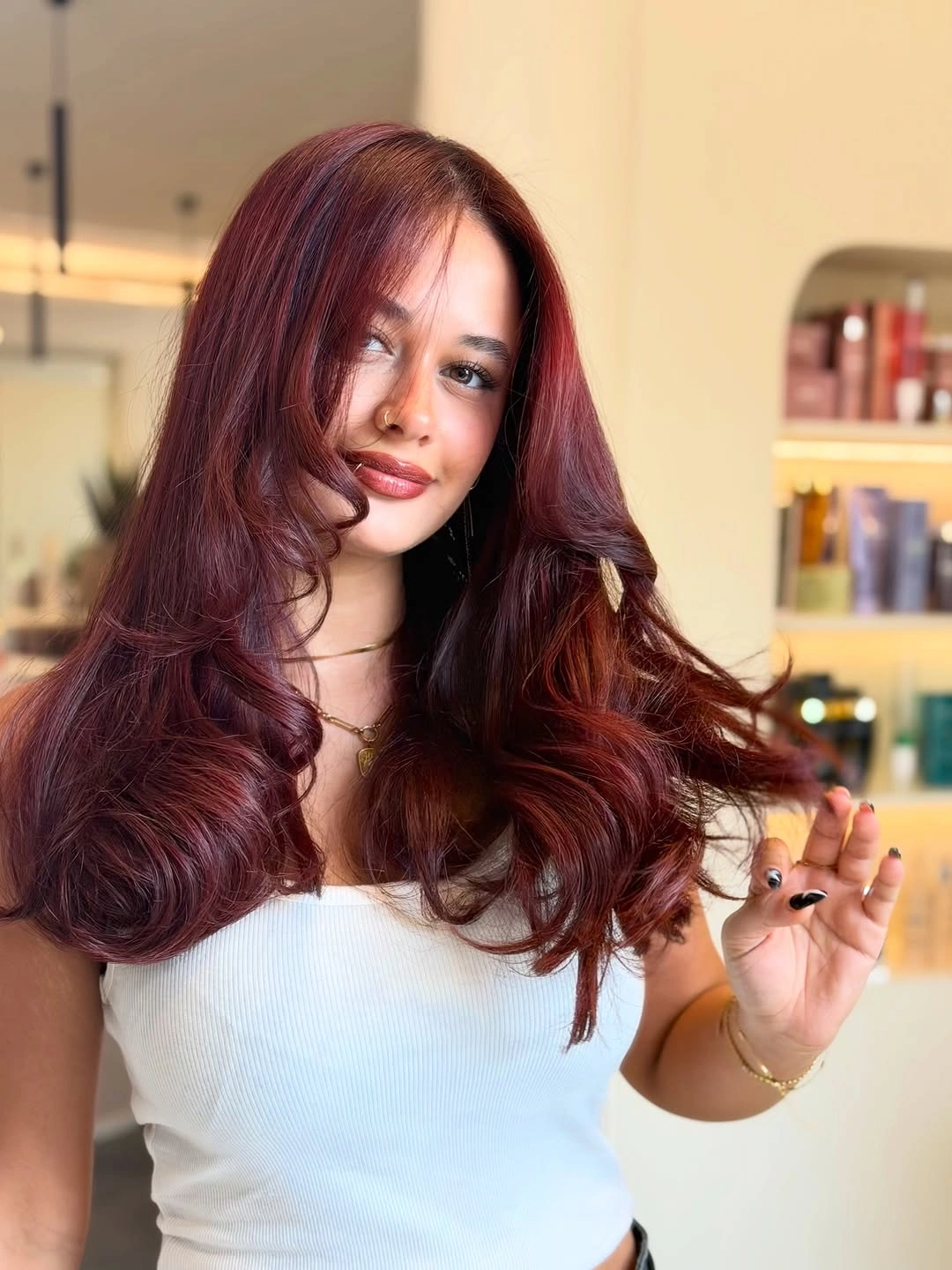 Long burgundy red hair with large center parted curls