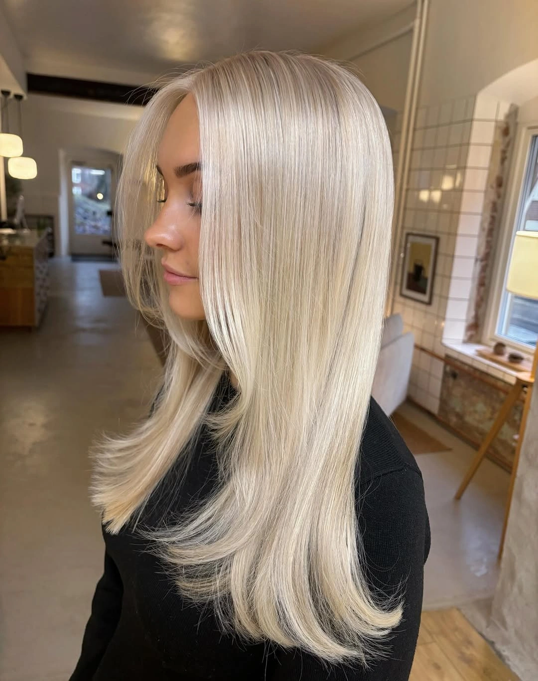 Side view of pale blonde layered hair with flipped ends