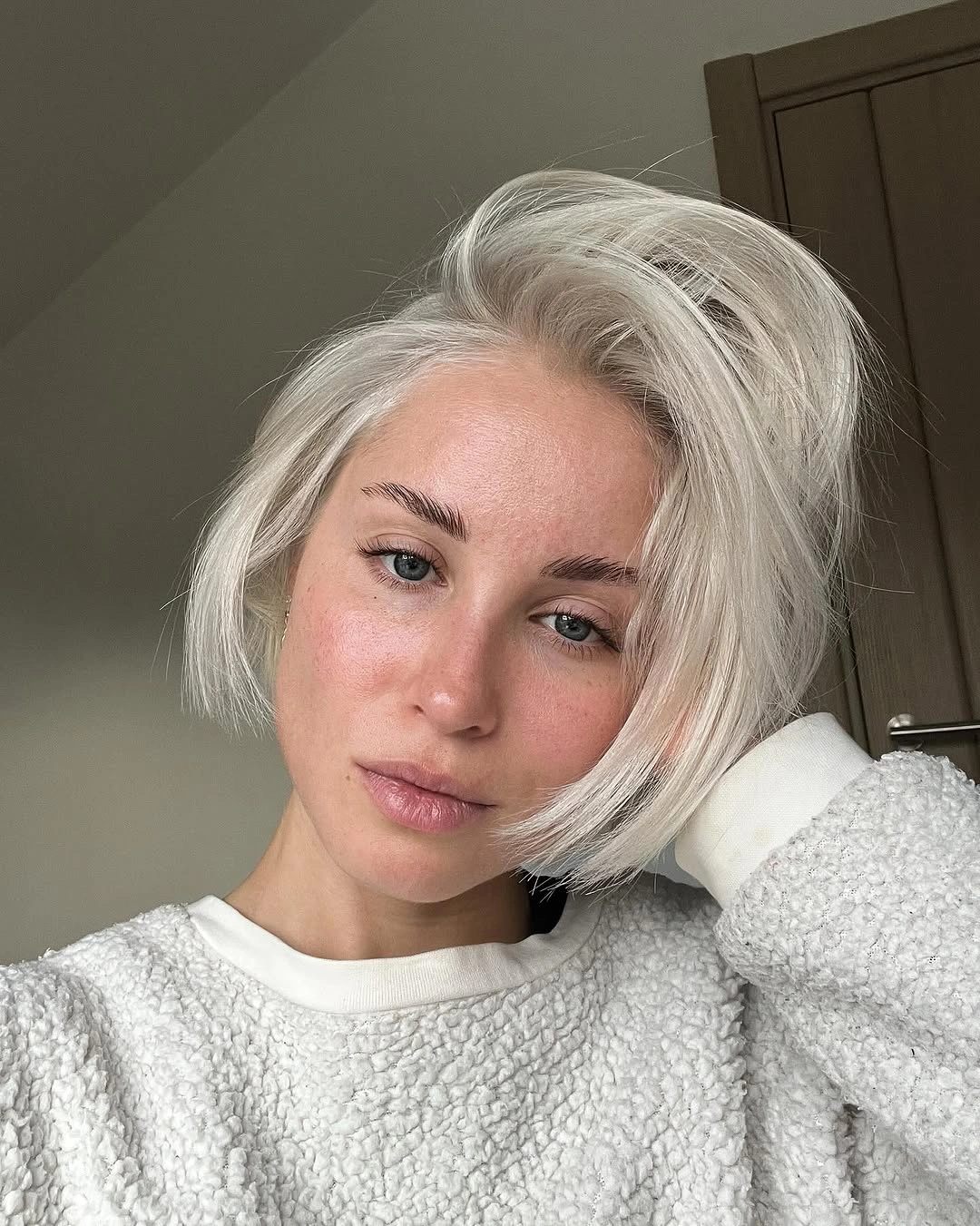Short silver white blonde bob with side swept volume