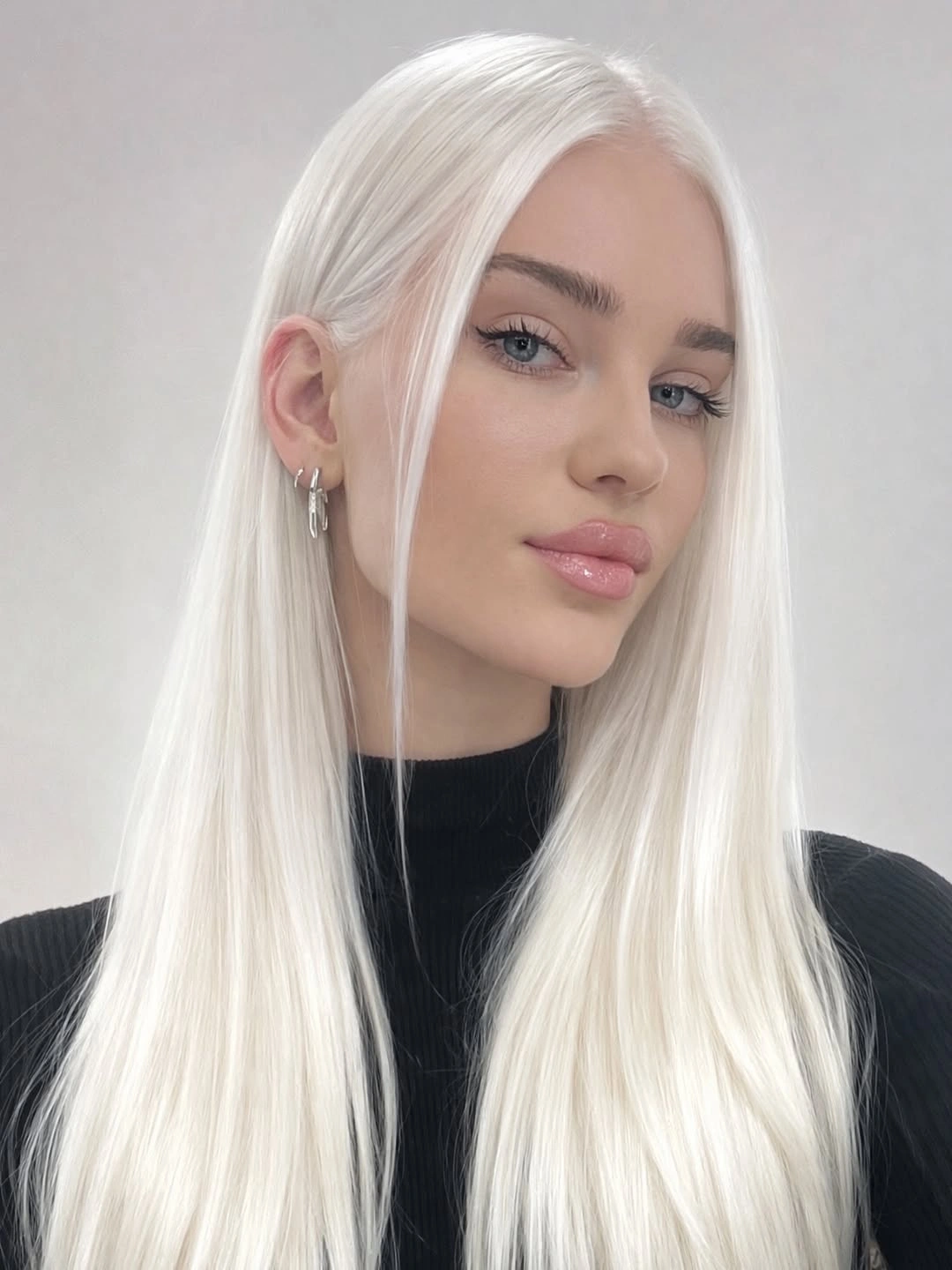 Very long white blonde hair with center part and black neckline