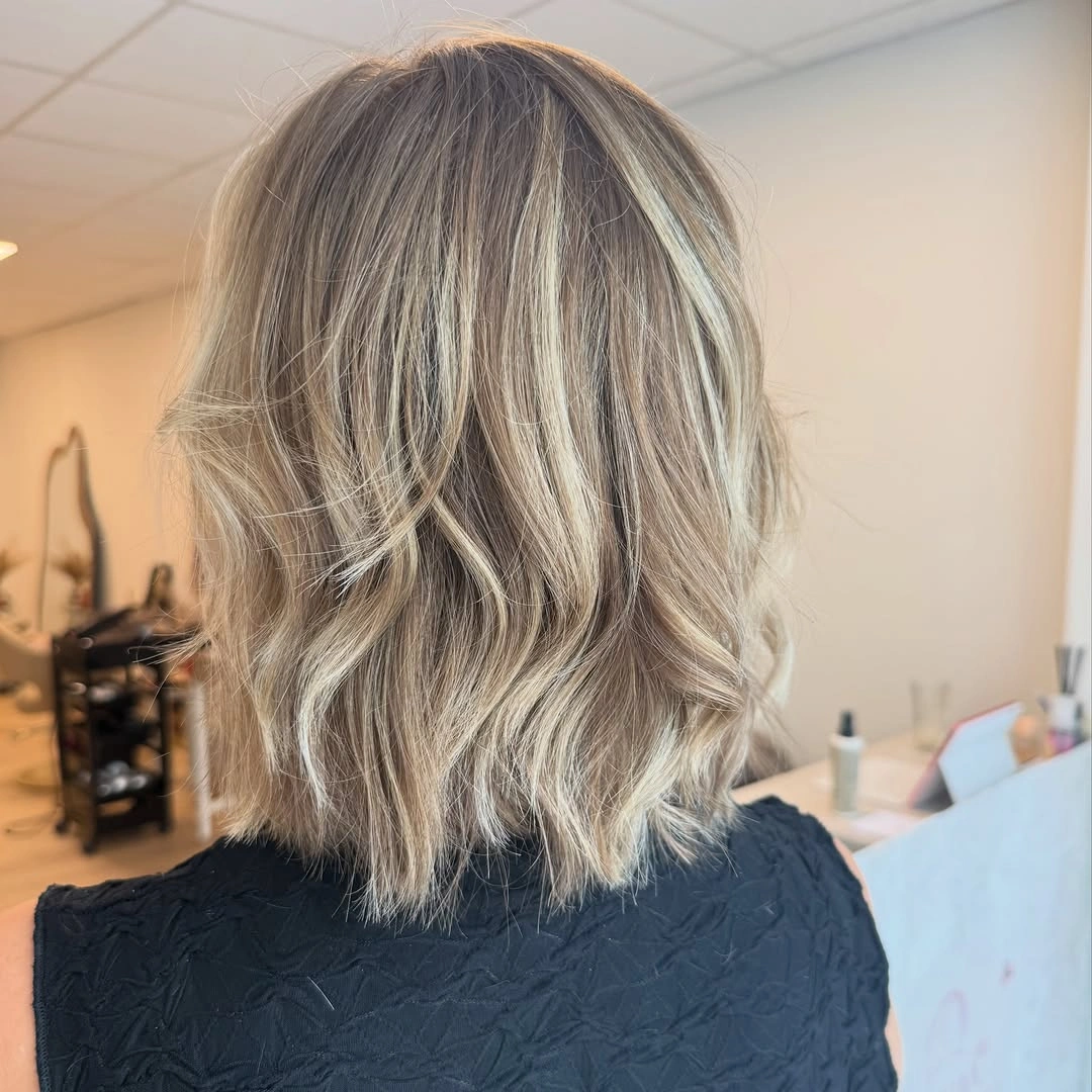 Back view of ash blonde lob with pale ribbons
