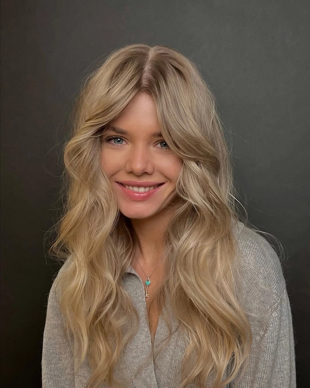 Long beige blonde waves with center part and curtain pieces