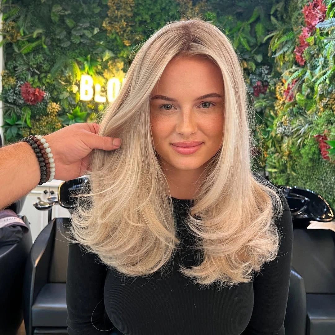 Front view of creamy blonde hair with rounded curled ends