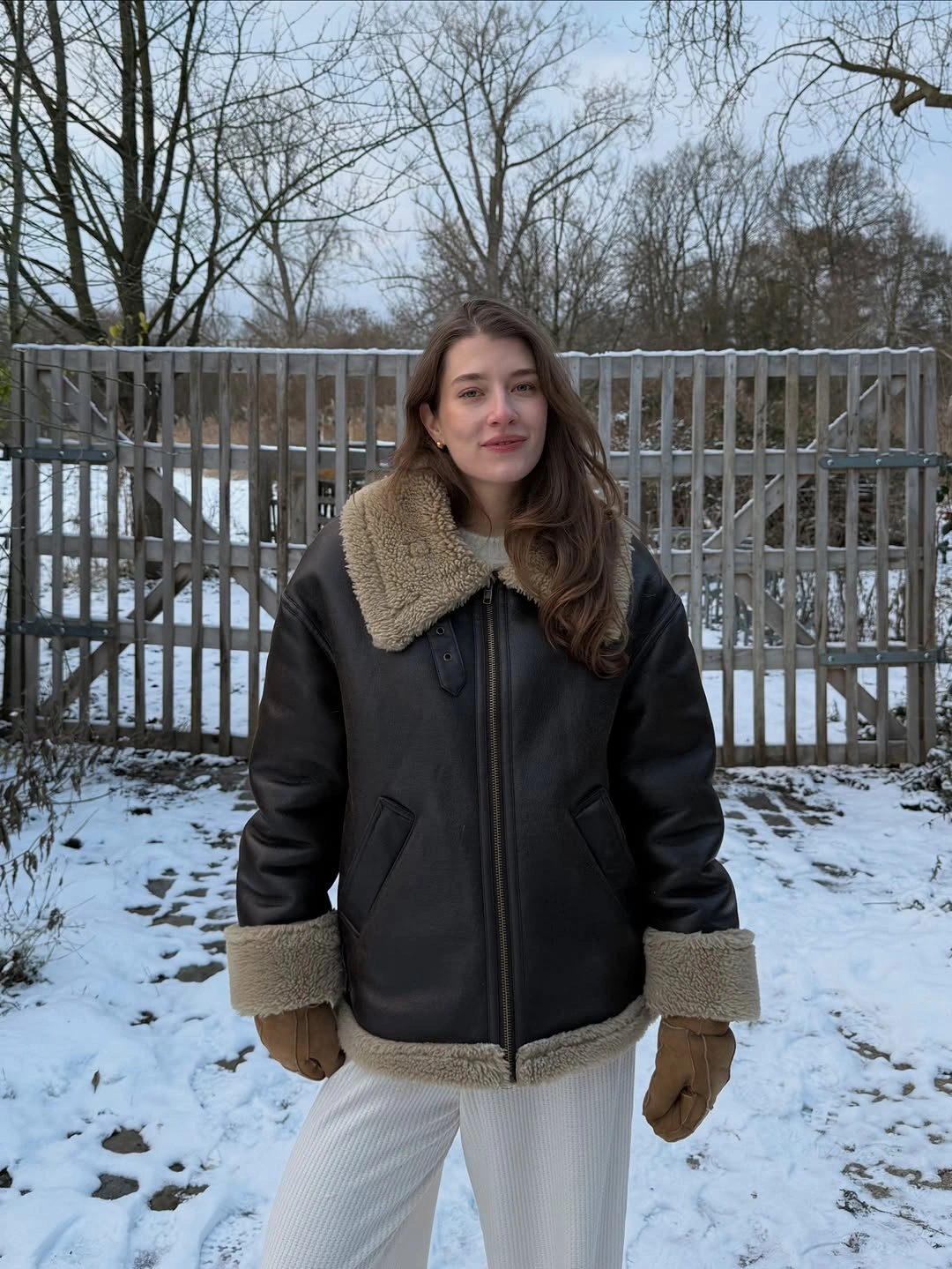 Dark aviator jacket beige trim gloves and pale ribbed bottoms