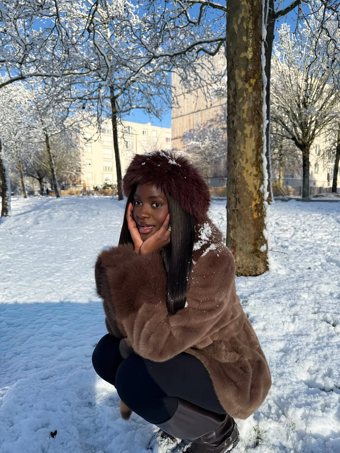 Brown fur-look coat matching hat leggings and tall dark boots