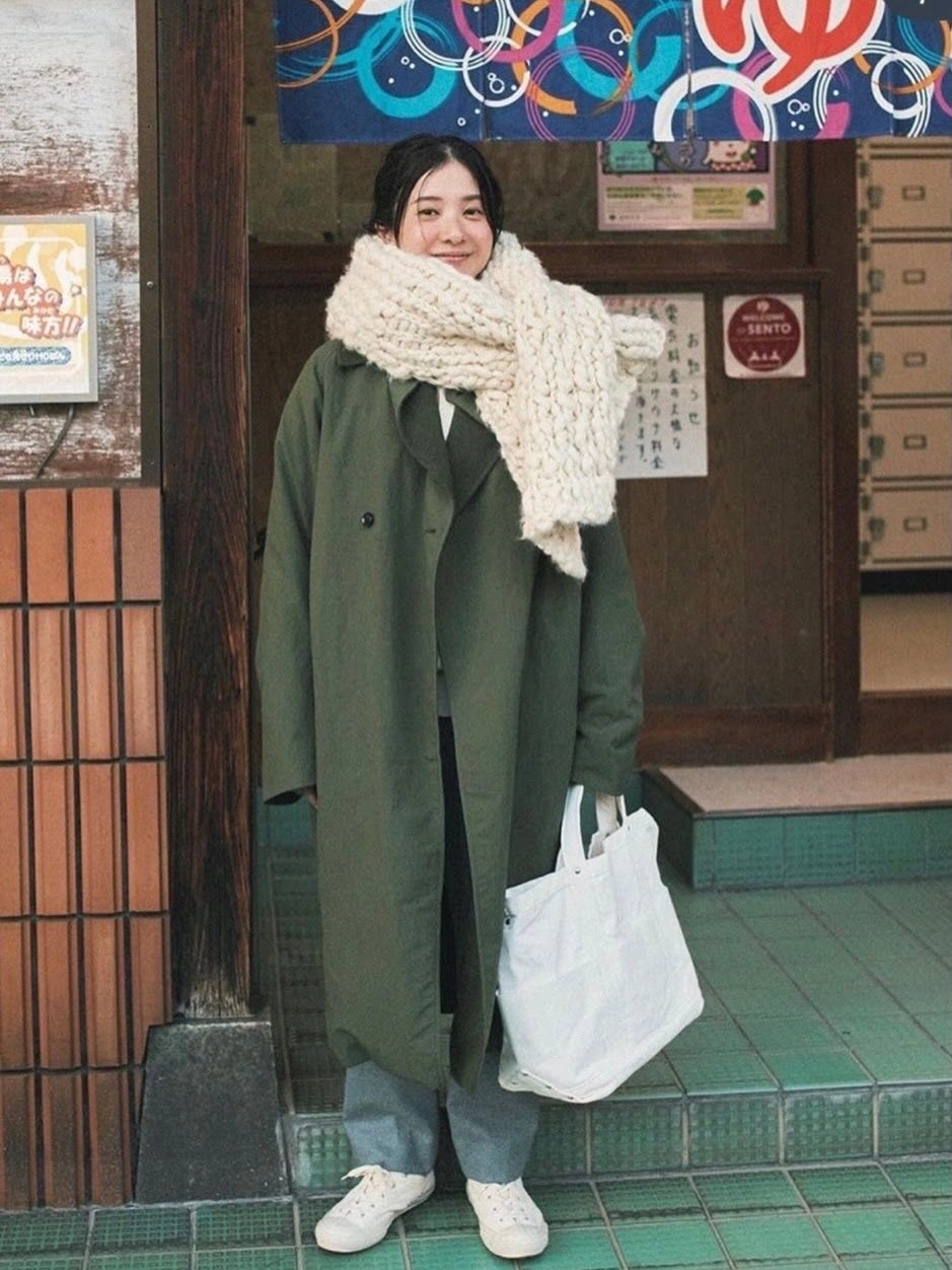 Olive long coat cream scarf jeans and white sneakers