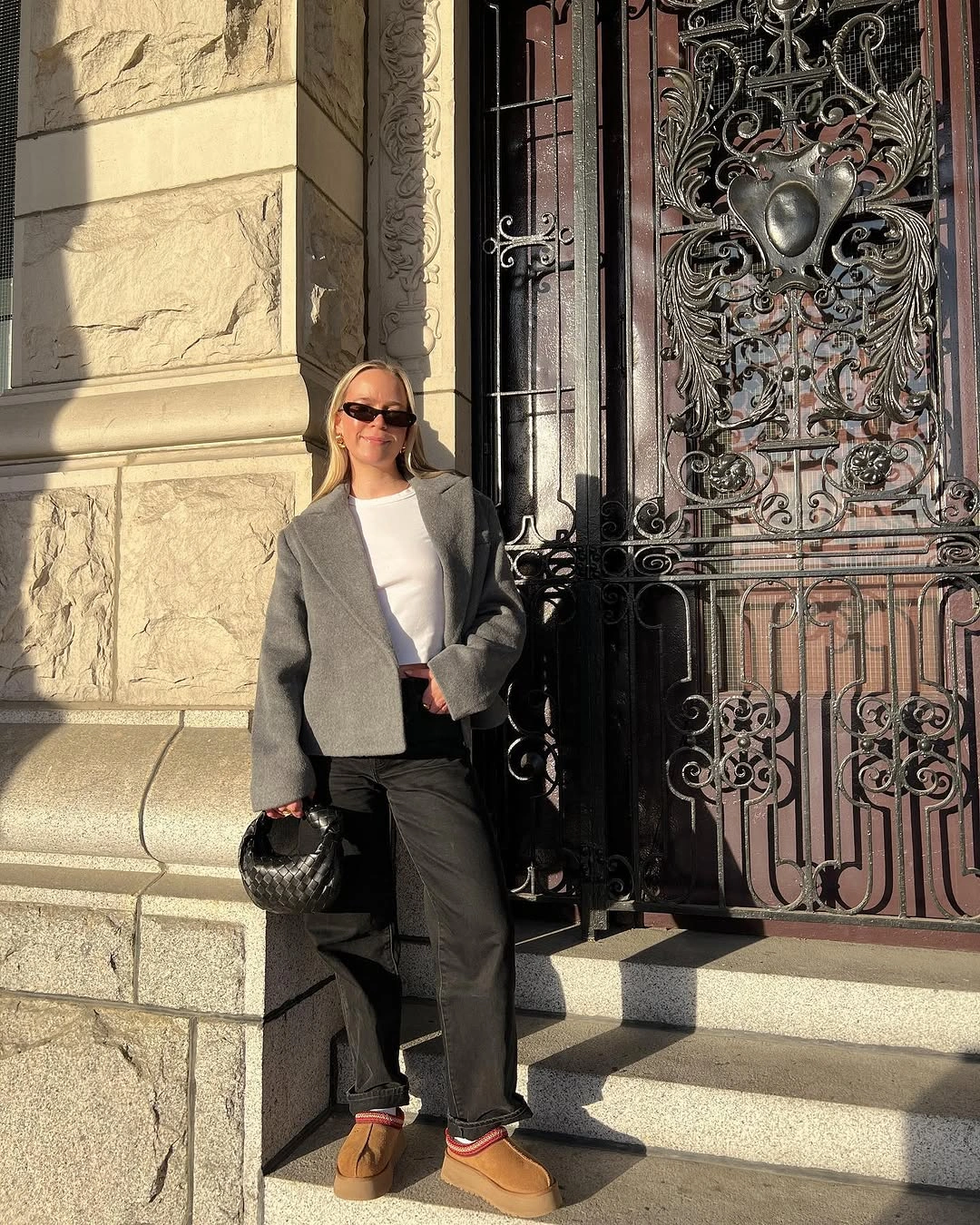 Gray blazer white top rolled trousers tan boots and sunglasses