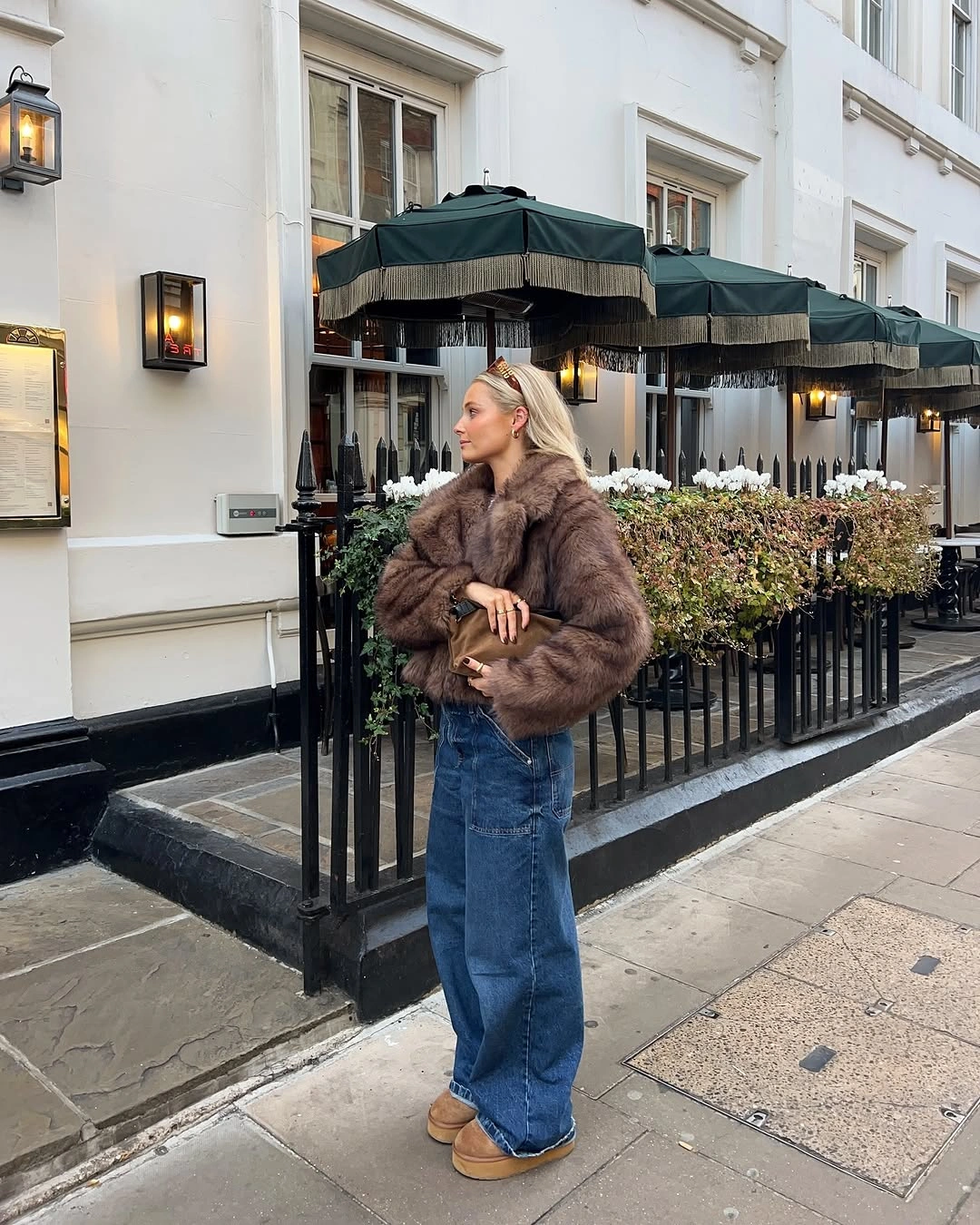 Brown plush jacket wide cuffed jeans and tan platform shoes