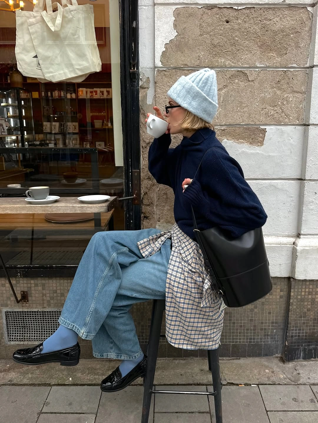 Oversized black coat scarf sheer-looking tights and tall boots