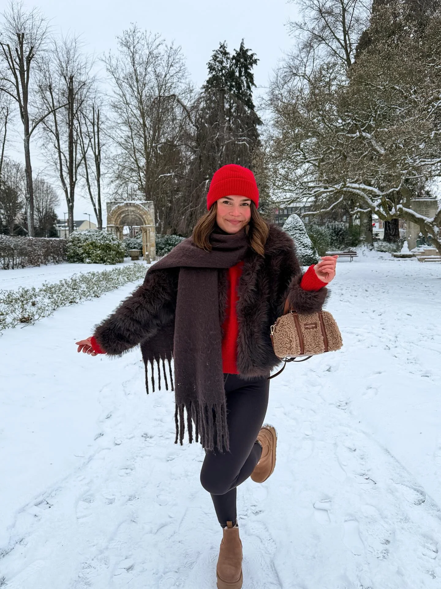 Gray fur-like jacket with white pants handbag and light footwear