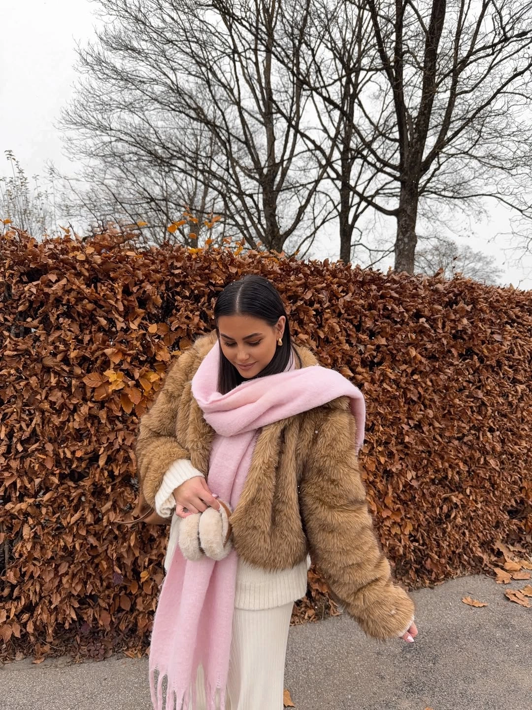 Brown leather-look padded jacket with gray jeans and patterned tote