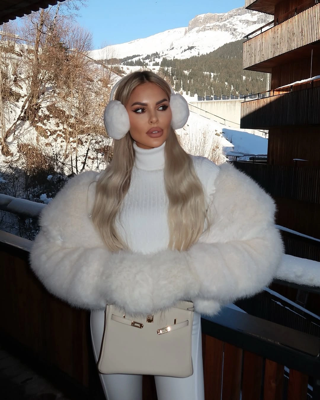 Cream fur-like coat with pink scarf and white pom-pom beanie