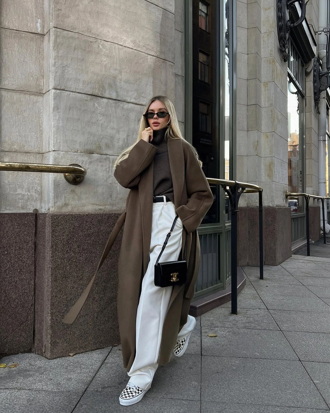 Cream shaggy jacket with black outfit and magenta cap sneakers