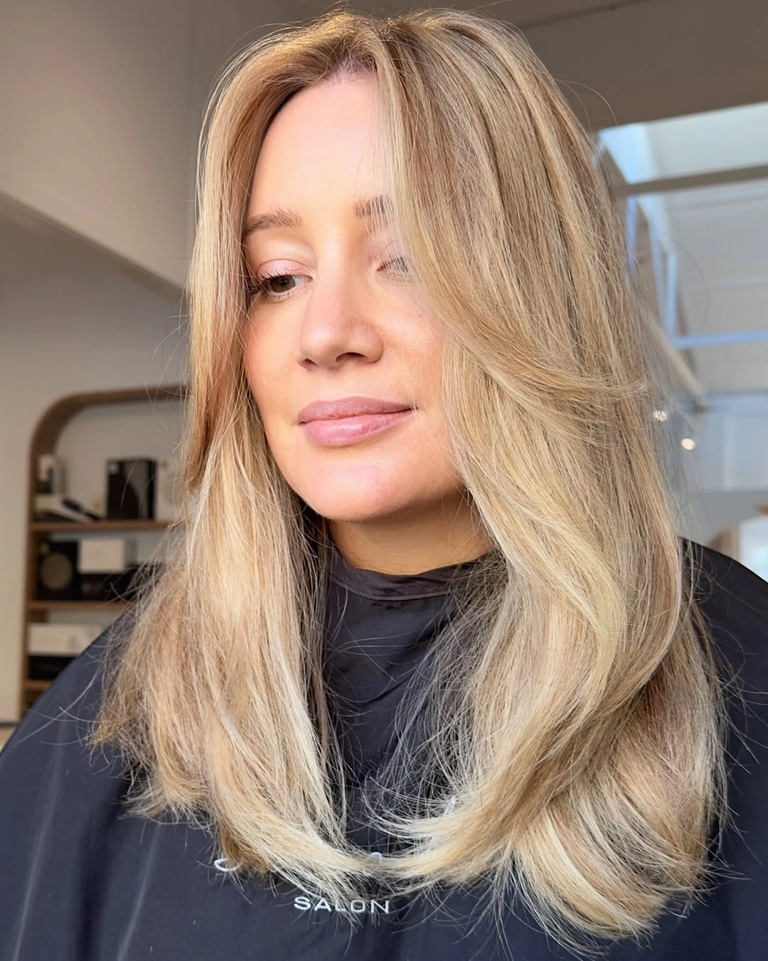 Warm beige-blonde hair with soft face-framing layers