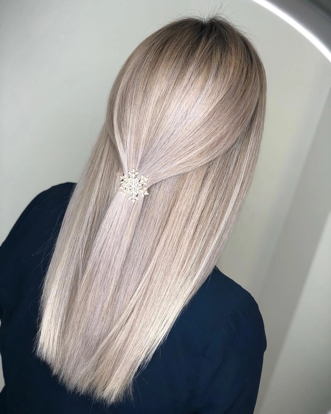 Long cool beige-blonde hair with fine pale ribbons and clip