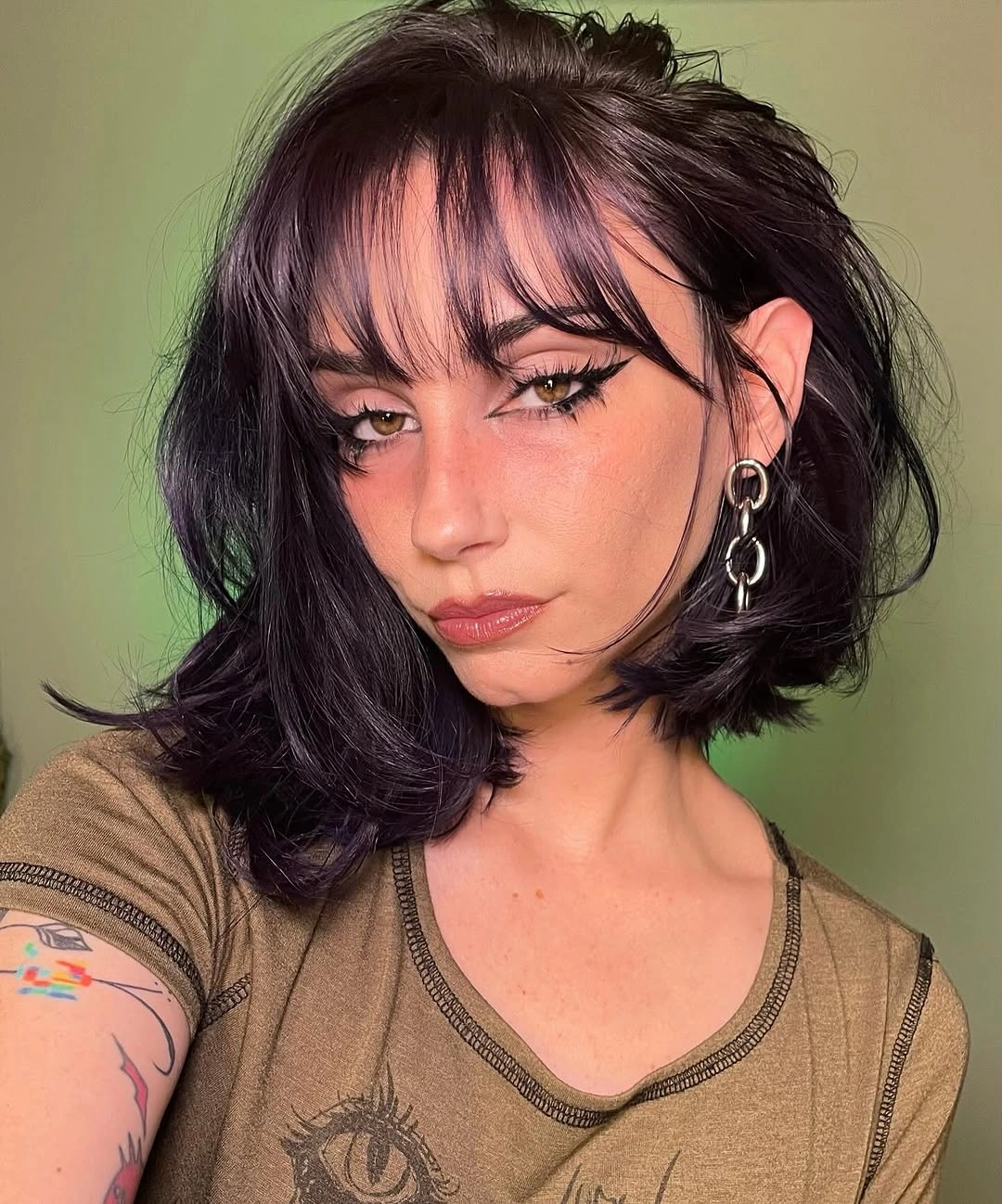 Short dark bob with wispy bangs and textured ends