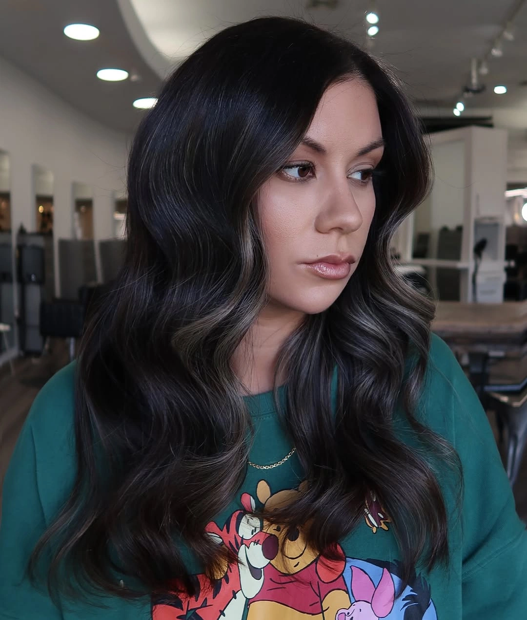 Long near-black hair with center part and soft waves