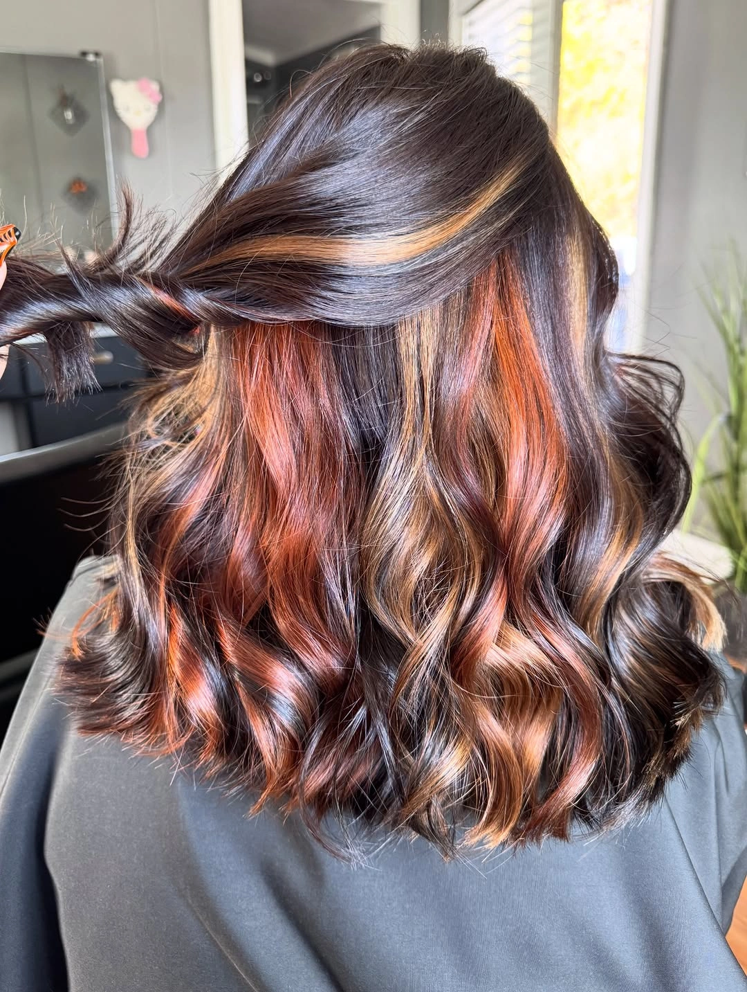 Dark brown waves with copper-orange ribbons underneath