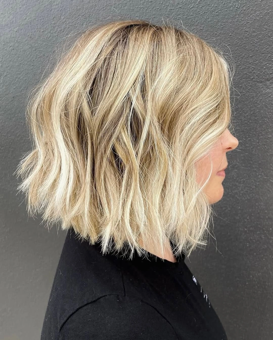 Medium blonde wavy bob with piecey lower edge
