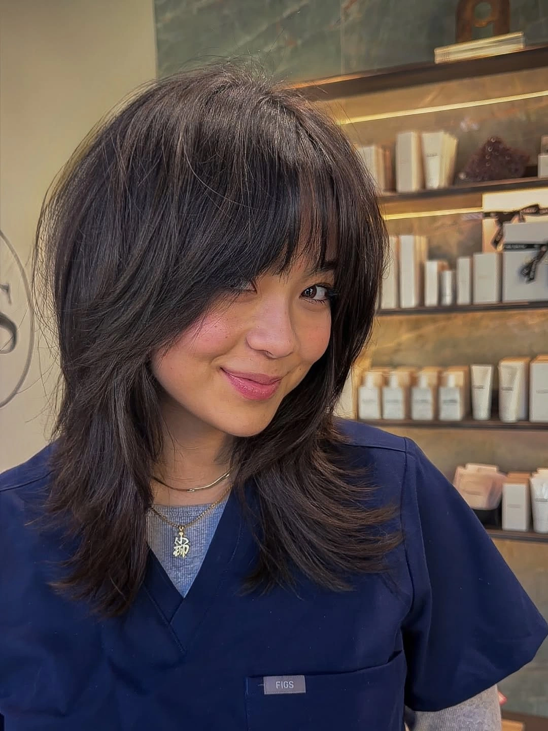 Medium dark shag with bangs and outward-pointing layered ends