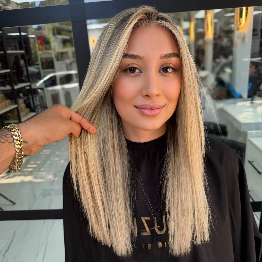 Long straight blonde hair with center part and even lower edge
