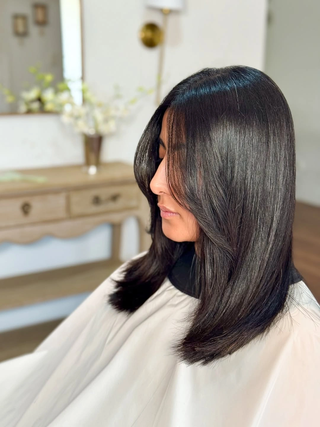 Medium sleek dark lob with softly curved ends