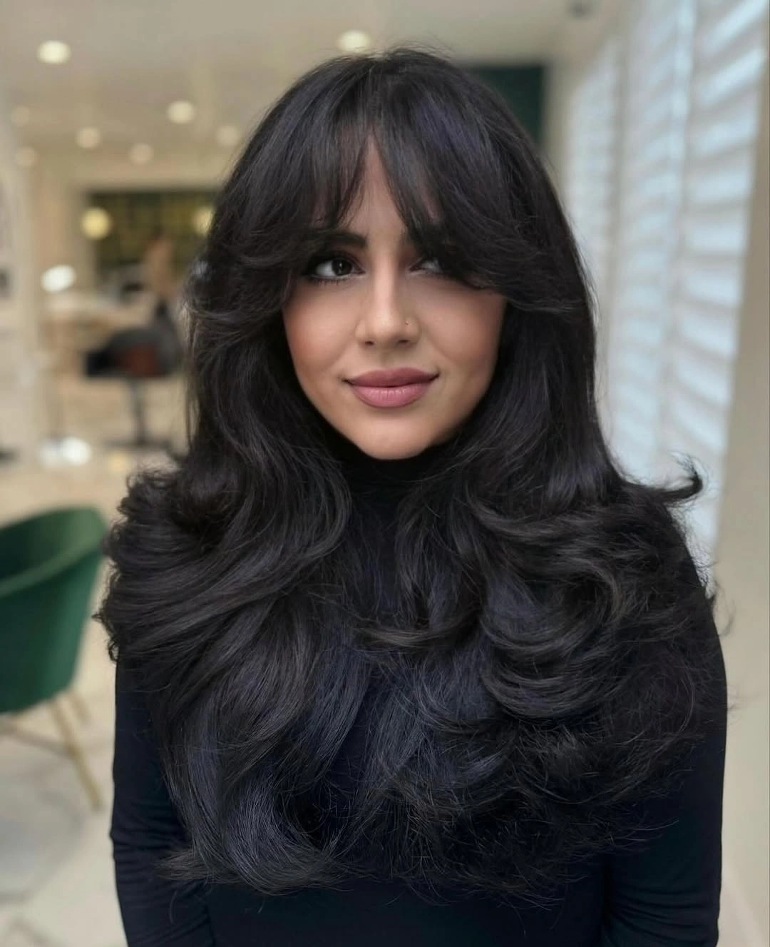 Long black layered hair with curtain-bang framing