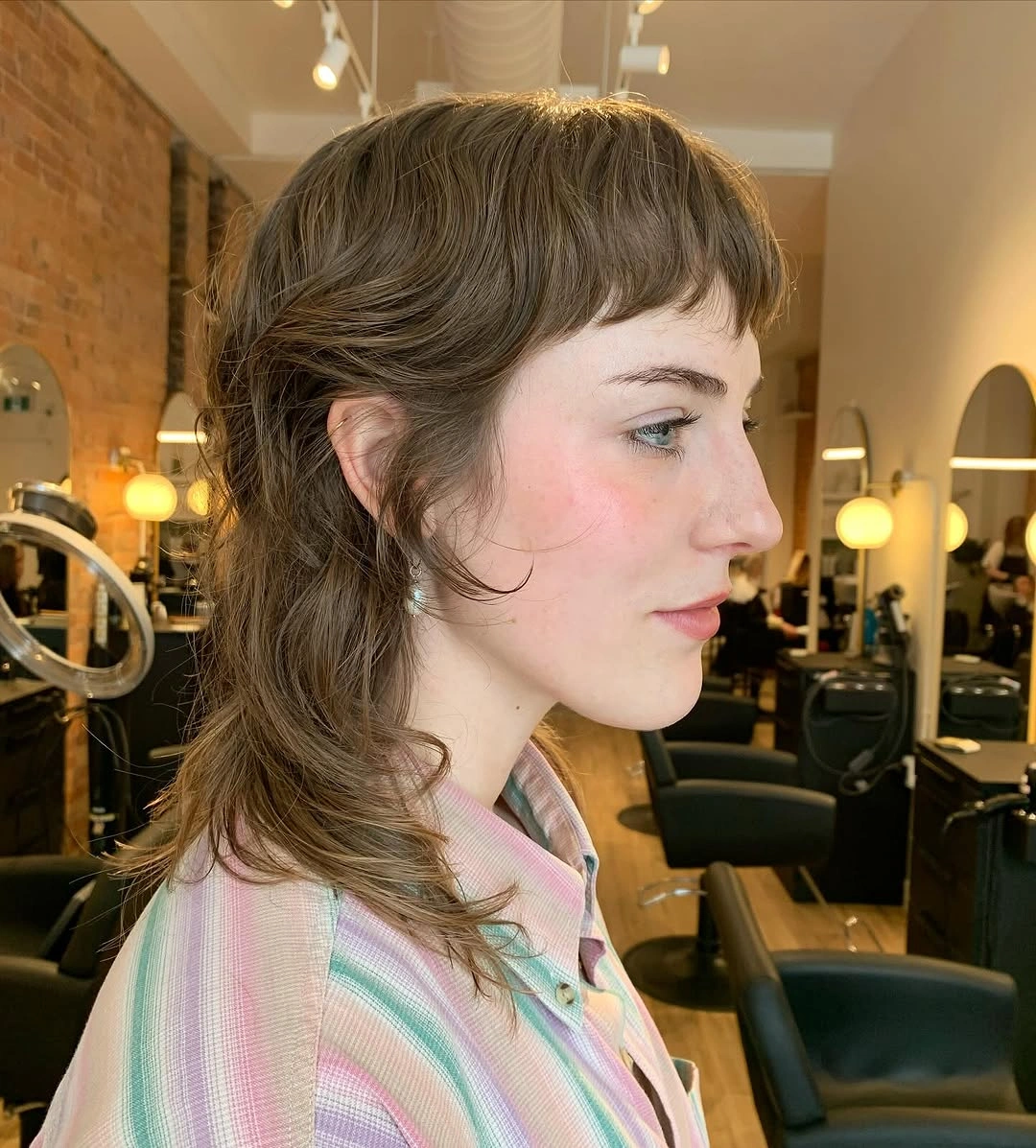 Short light-brown choppy cut with longer back and nape