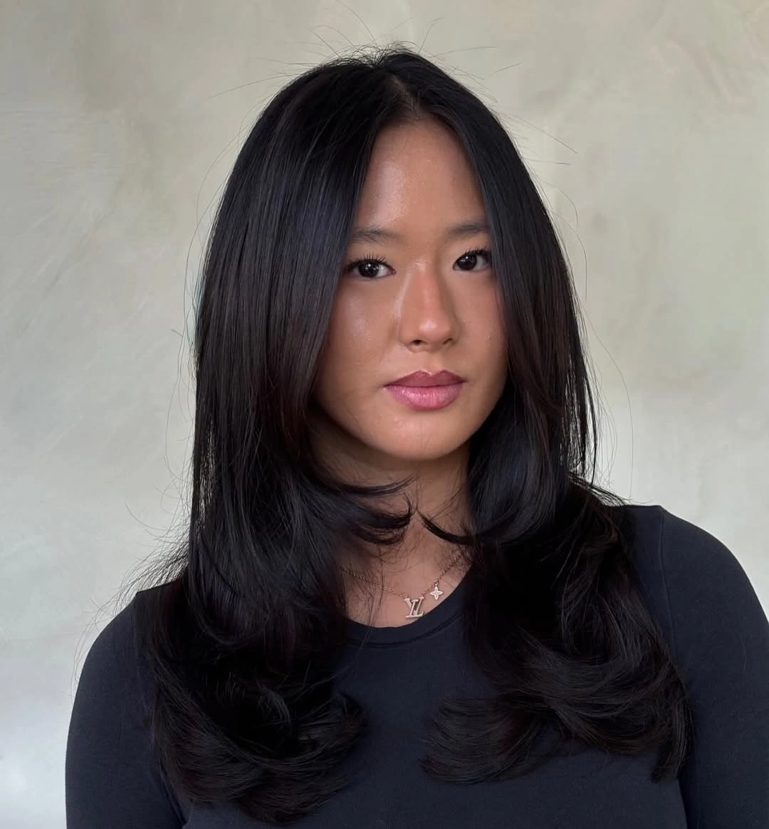 Long black hair with shorter curved front layers
