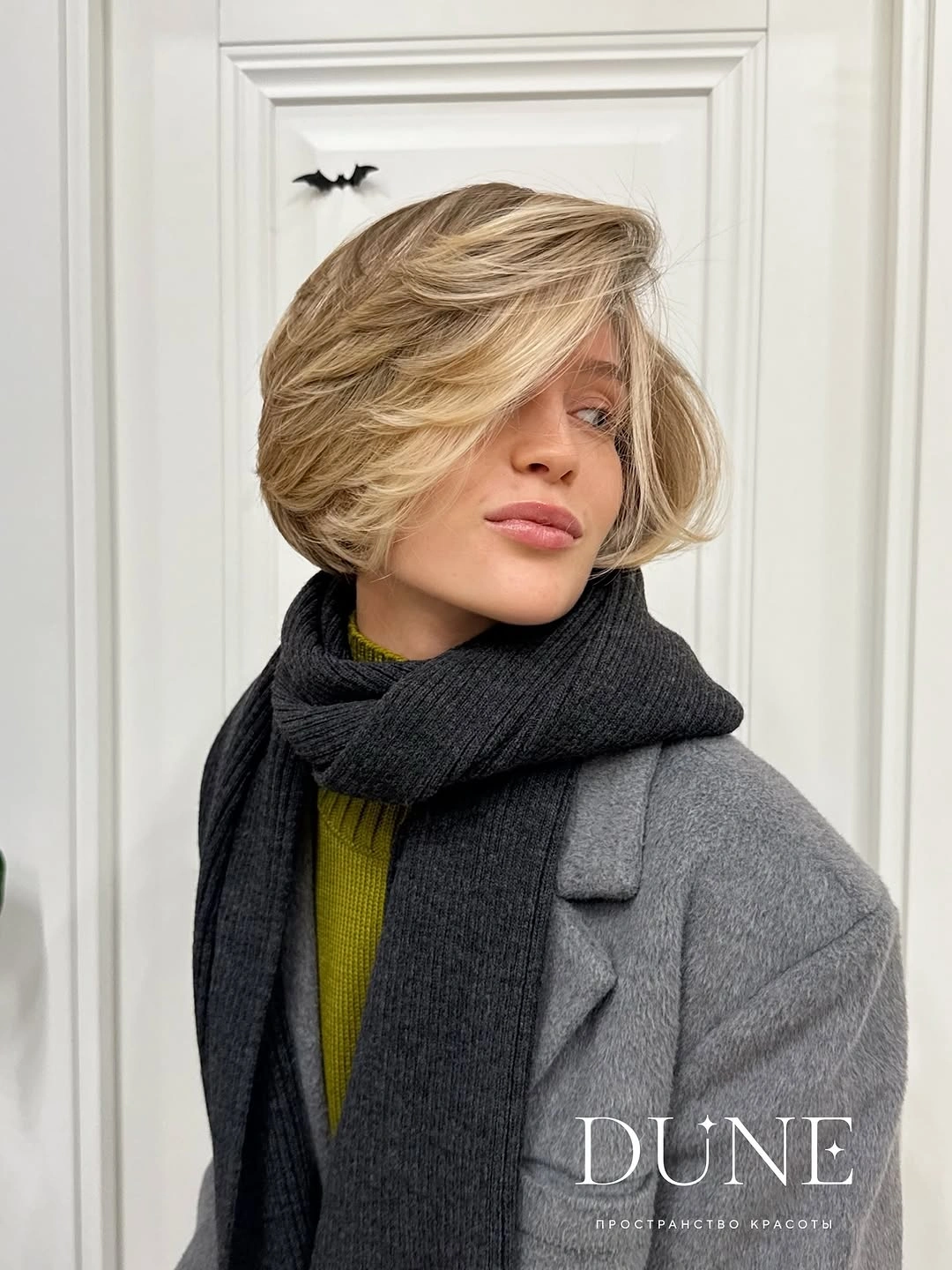 Short blonde rounded bob with pronounced side sweep