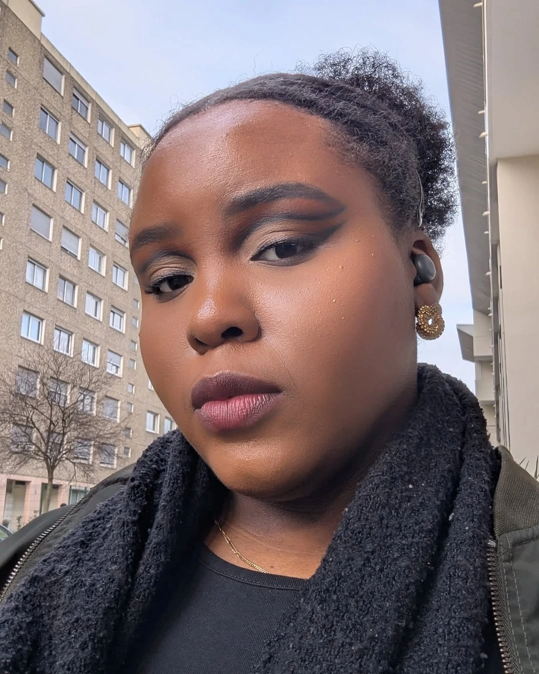 Pulled-back textured hair with compact rounded shape