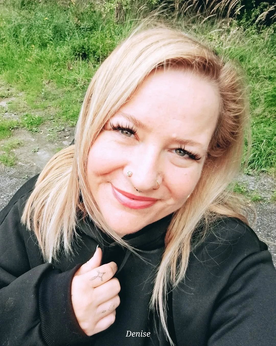 Blonde shoulder-length lob with side part and bent ends