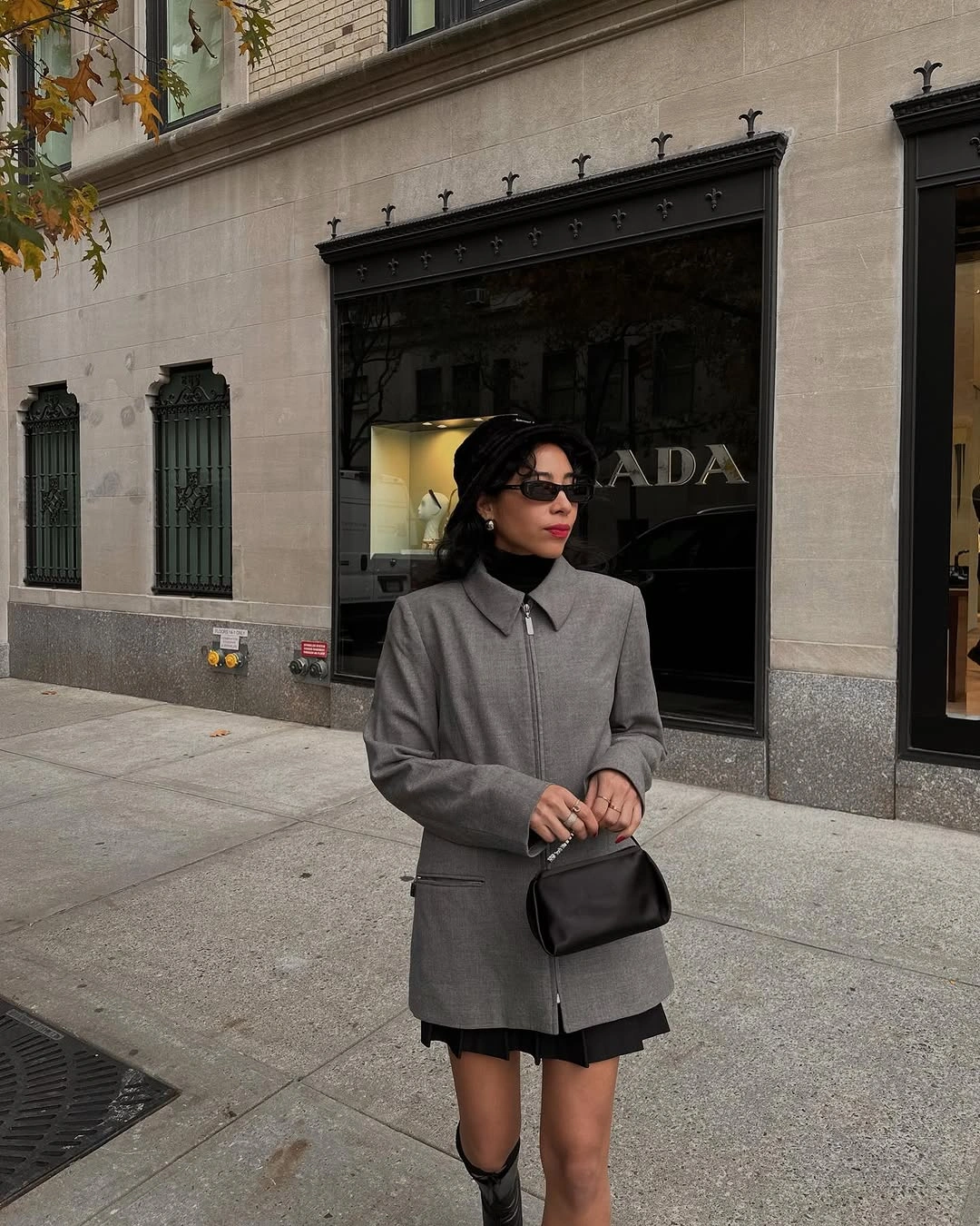 Woman in structured gray coat with tall black boots