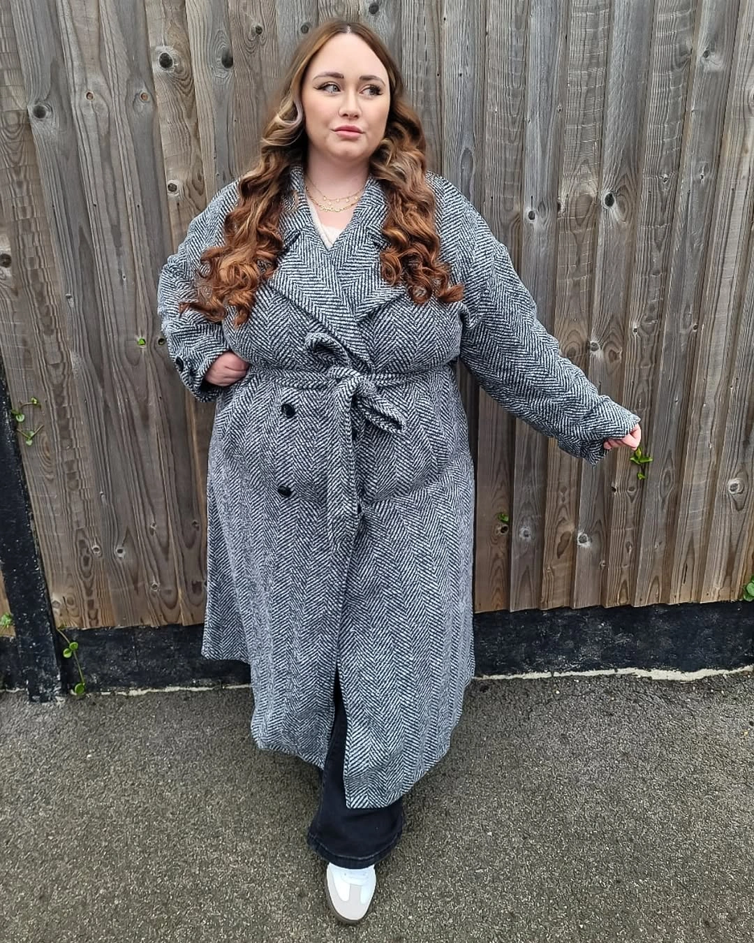 Gray herringbone belted coat over black lower layer