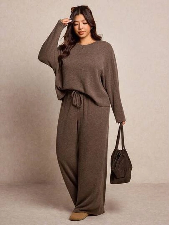 Brown loose top and wide drawstring pants with dark handbag