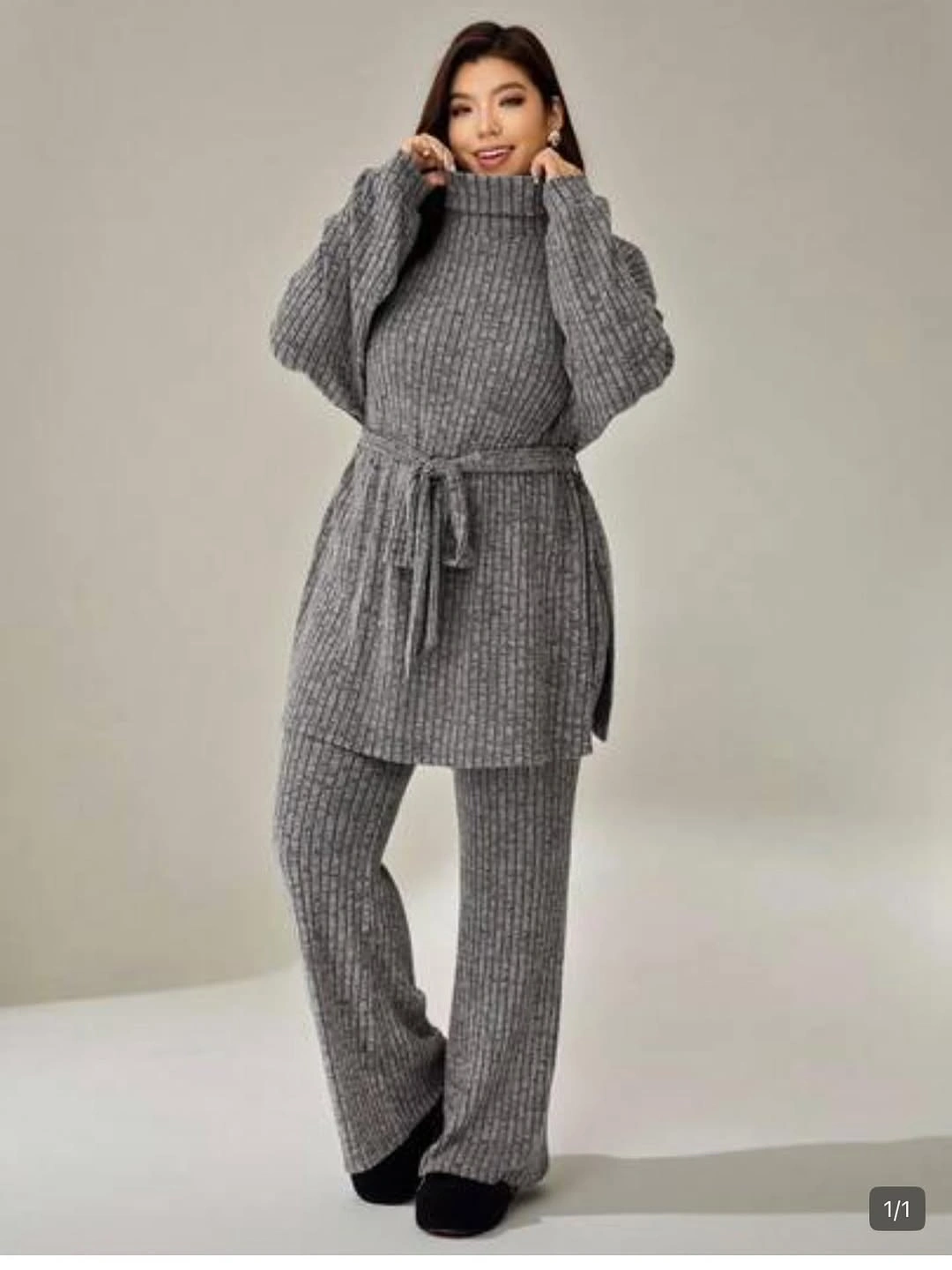 Gray ribbed high-neck top with wide pants and dark shoes