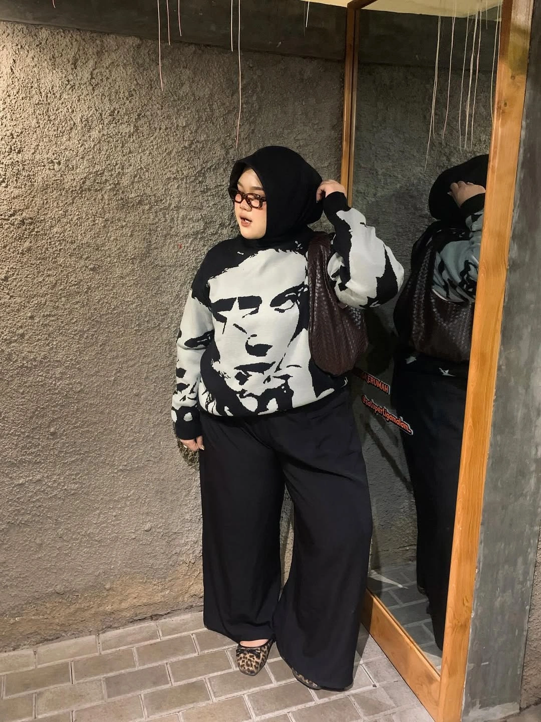 Black headscarf with graphic top and wide black pants