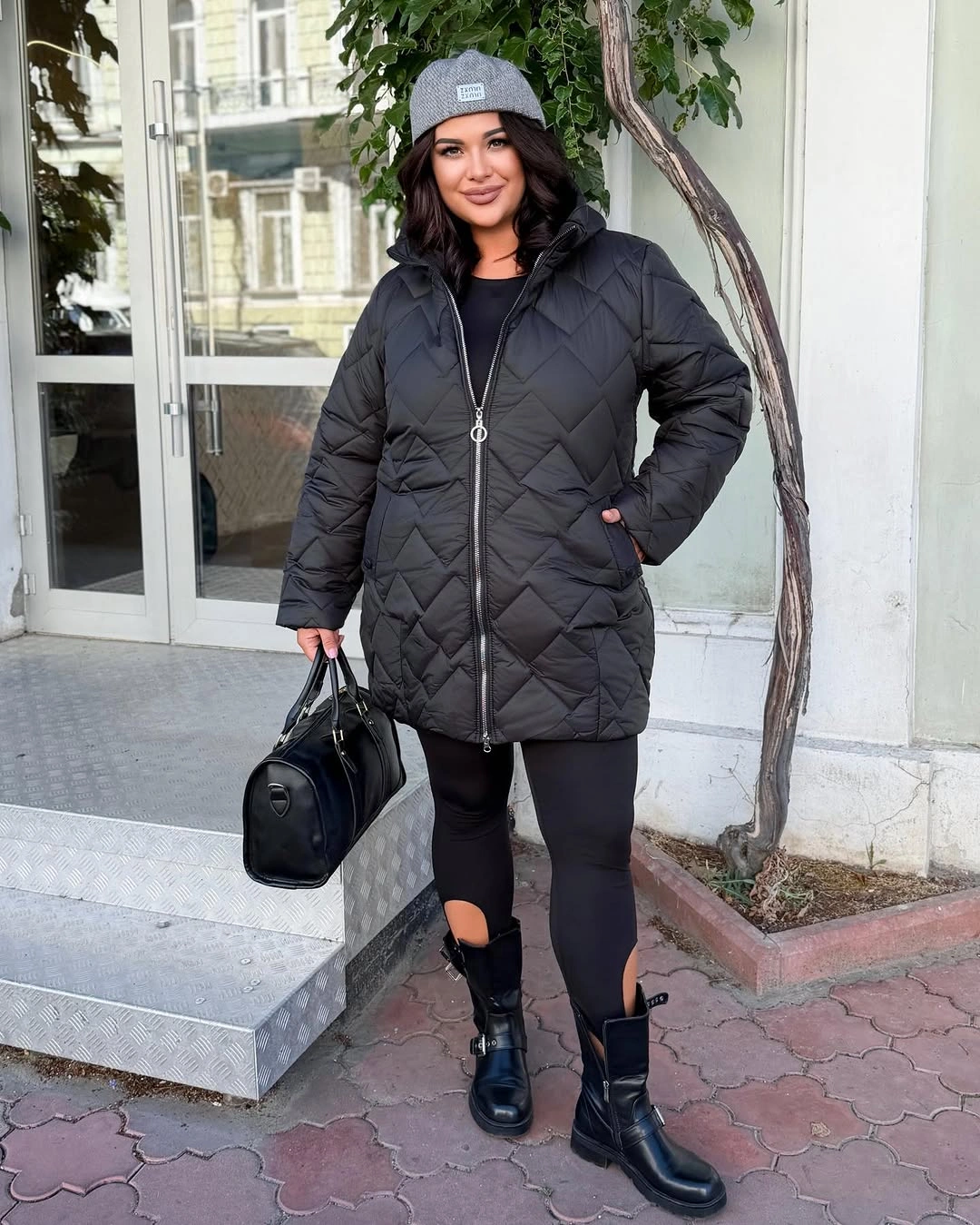 Black quilted jacket with gray beanie and chunky boots