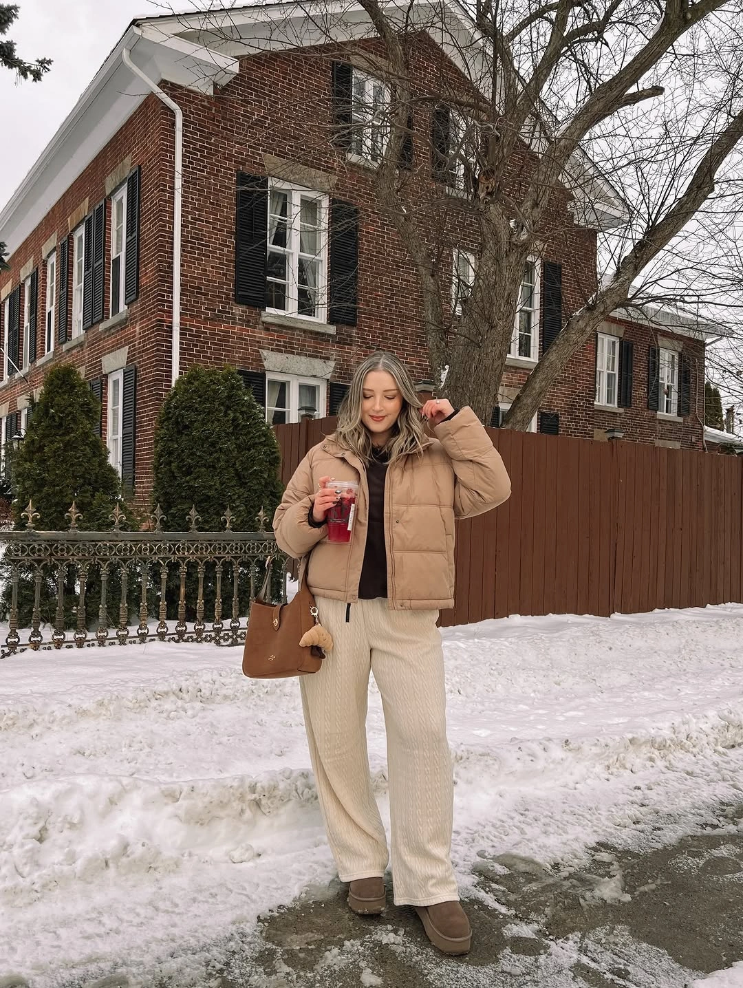 camel quilted vest with cream wide-leg trousers and brown shoulder bag