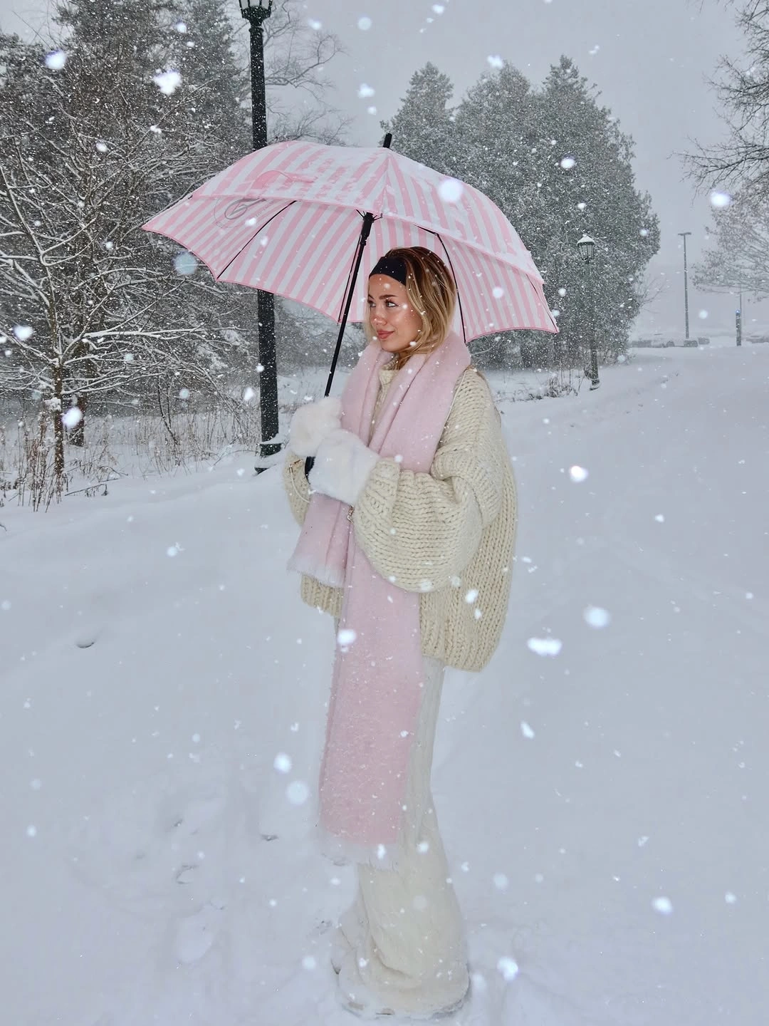 cream cable knit with pale pink long skirt scarf umbrella and light boots
