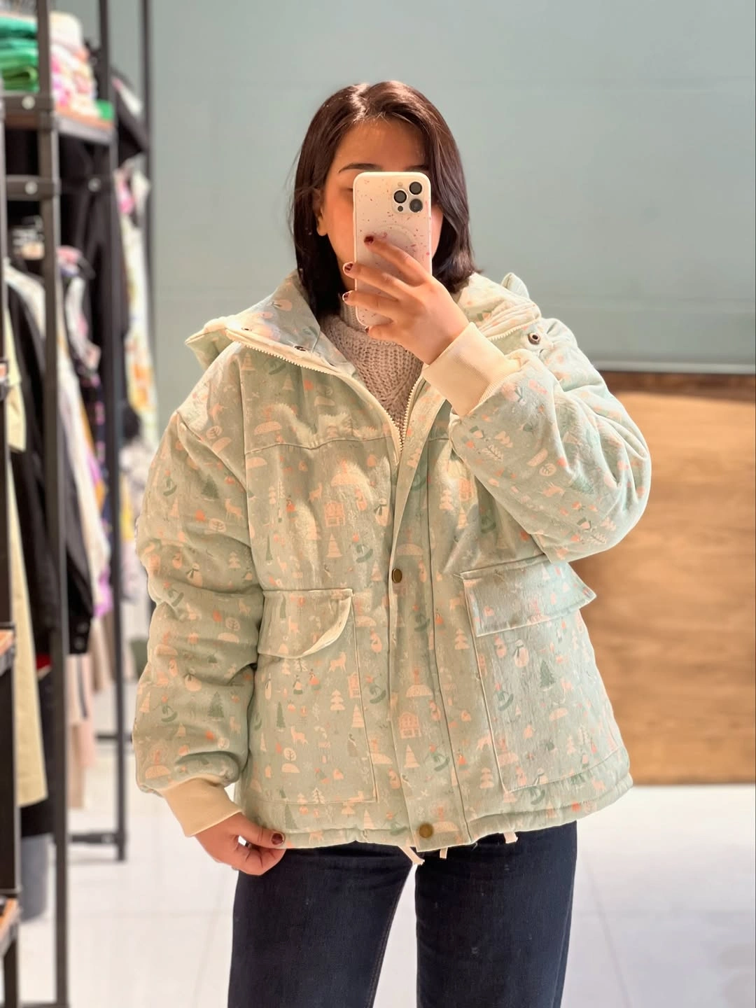 pale mint patterned puffer jacket over beige knit and dark blue jeans