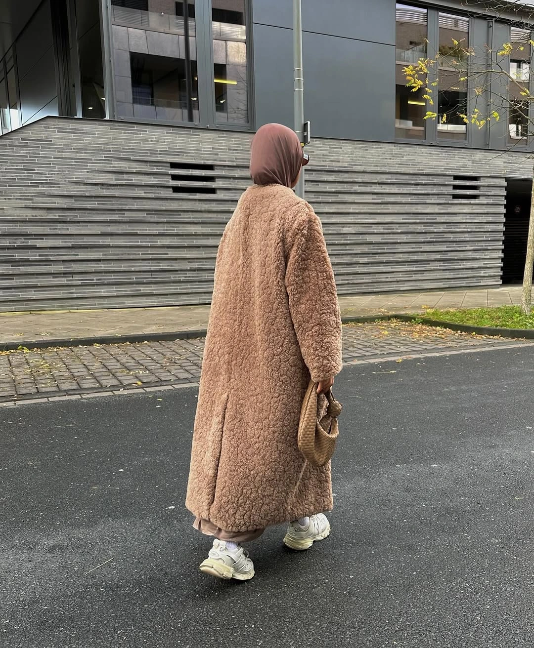 long camel textured coat with taupe headscarf neutral trousers and light sneakers