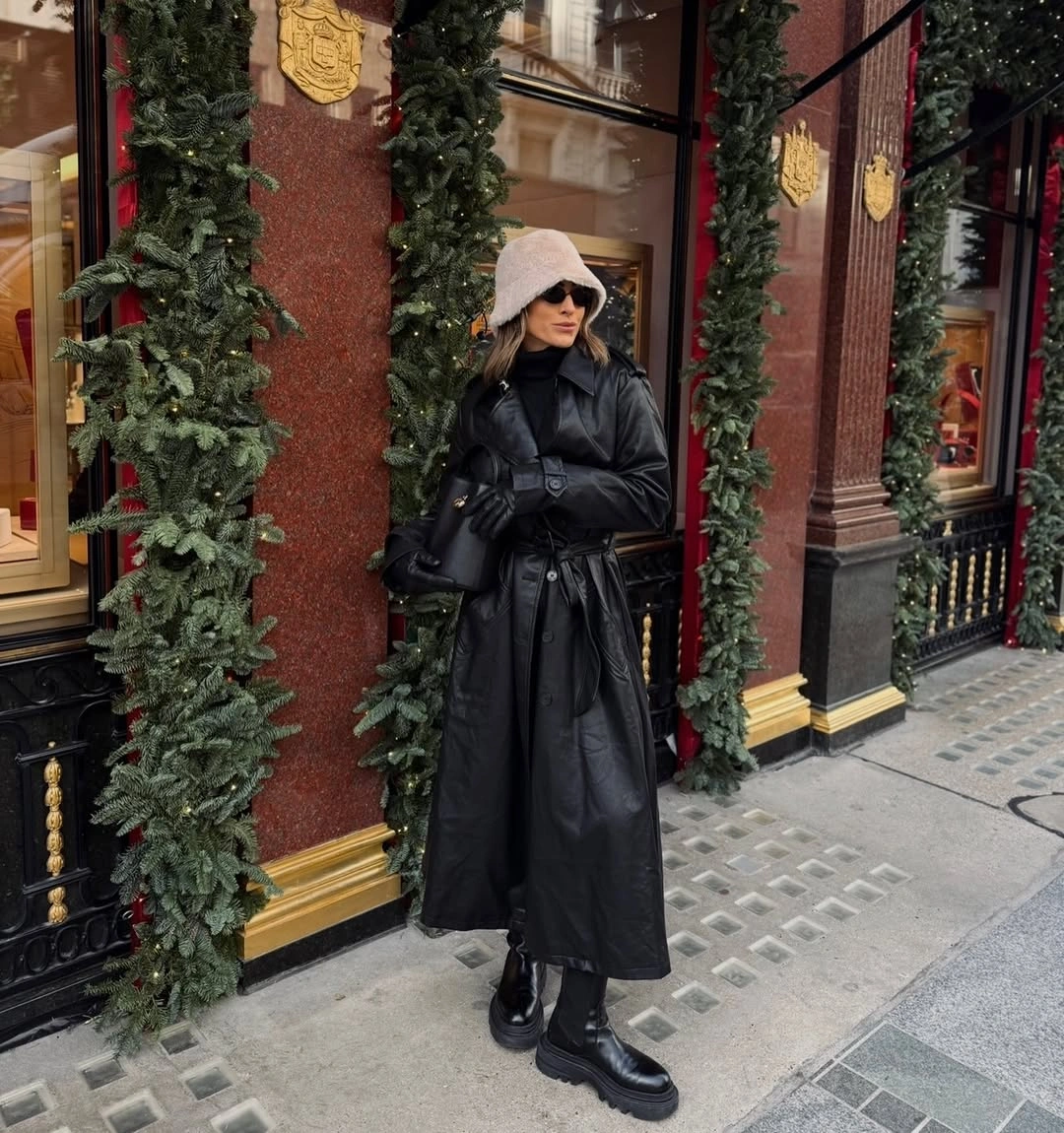 long belted black puffer coat with pale bucket hat and black ankle boots