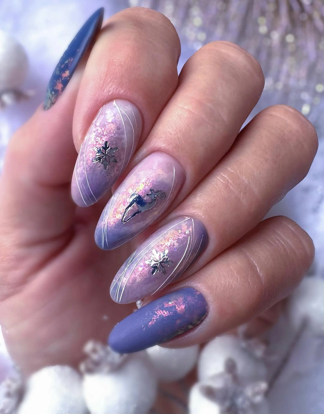 Short pastel almond nails with snowflakes and curved white lines
