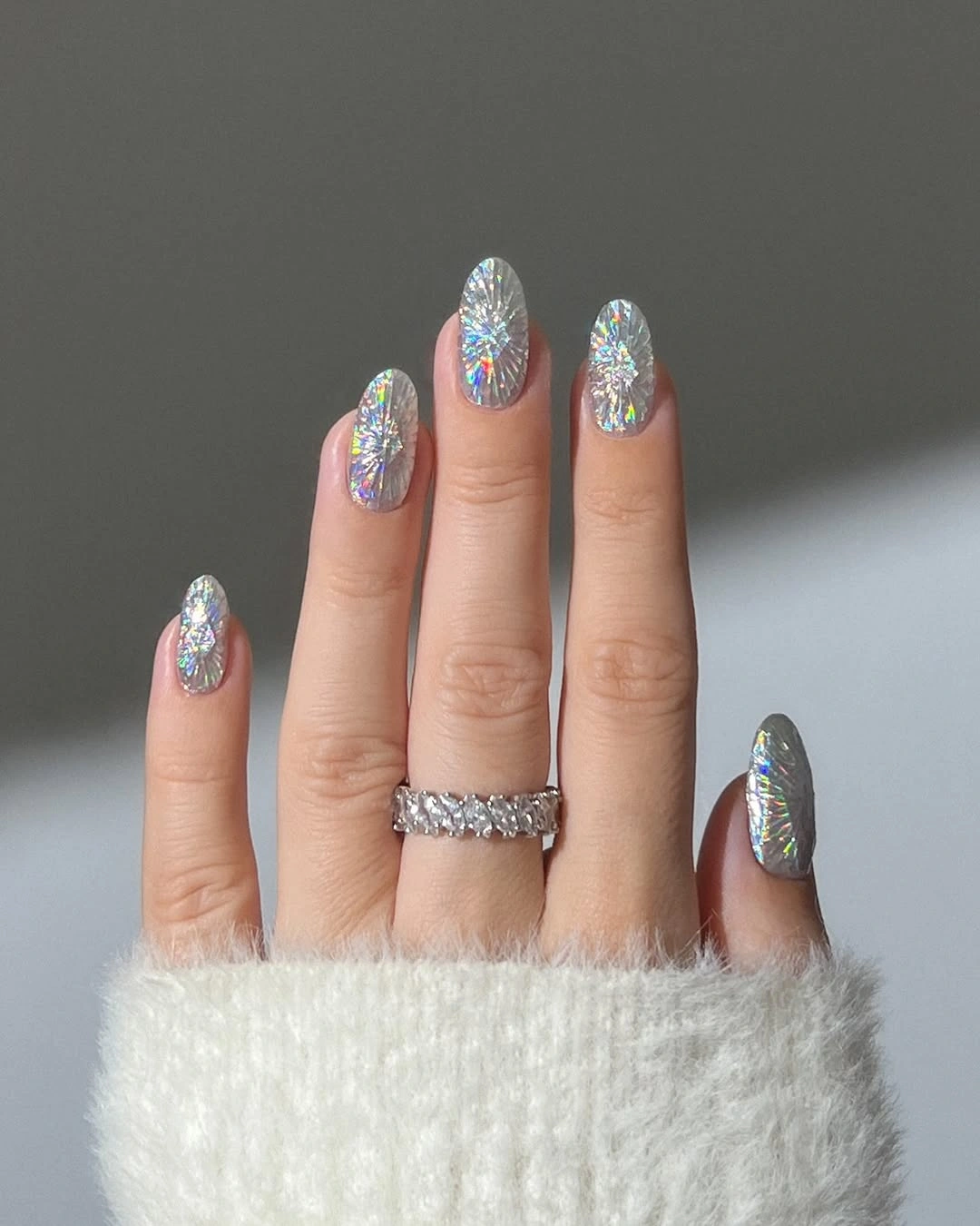 Short almond nails with reflective holographic silver shine